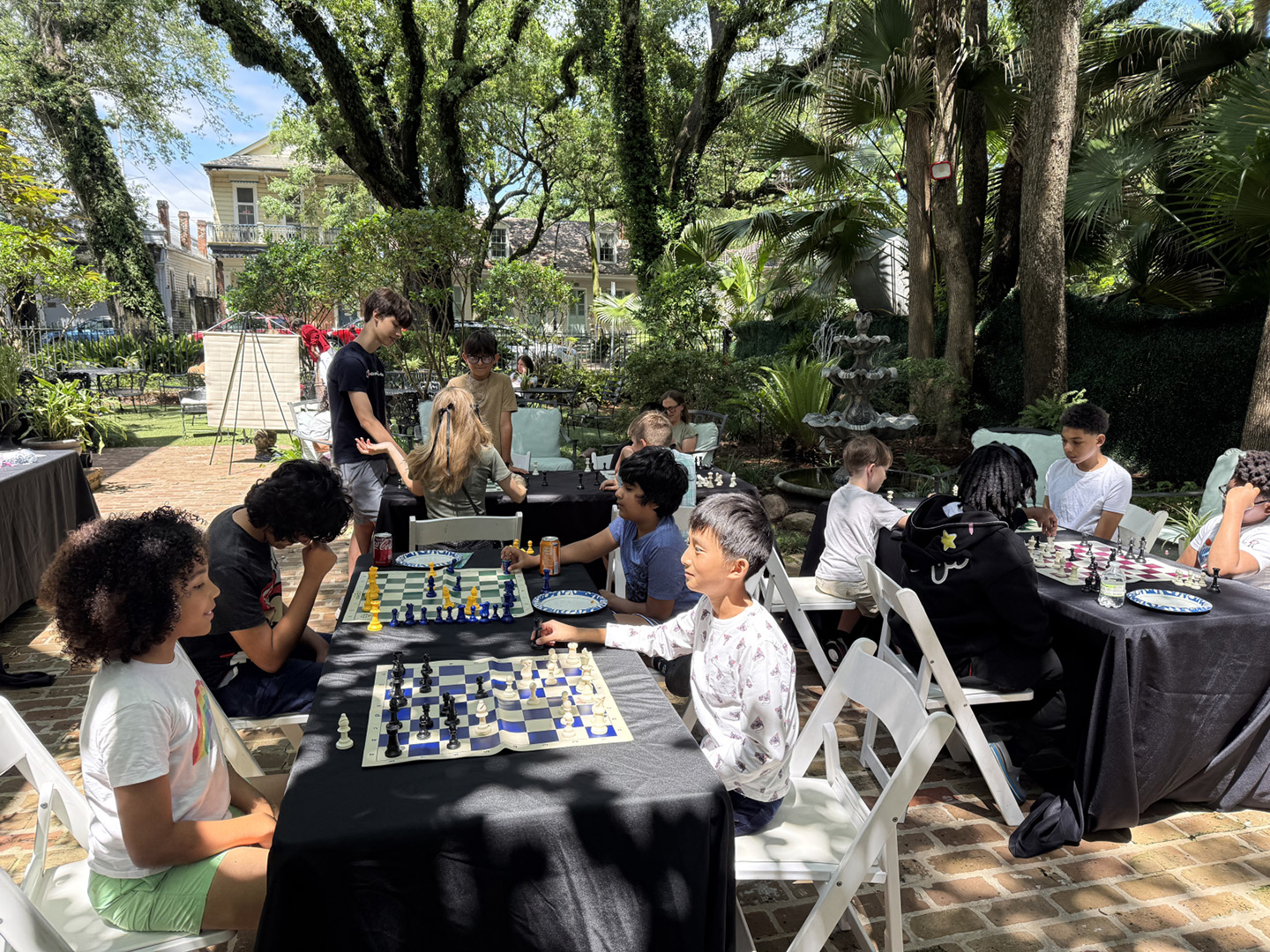 Kids play rounds of chess in the courtyard of Le Musee de f.p.c in New Orleans.