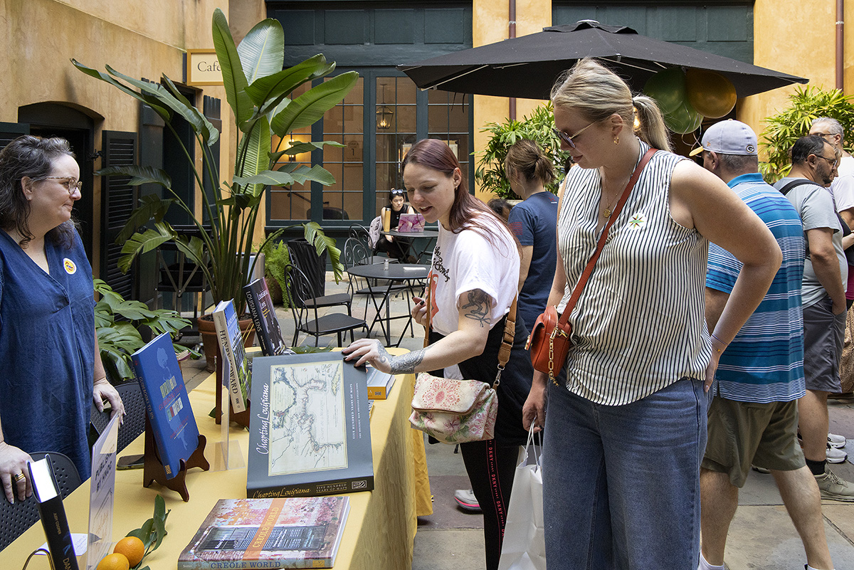Visitors look at books at HNOC's annual Holiday Market.