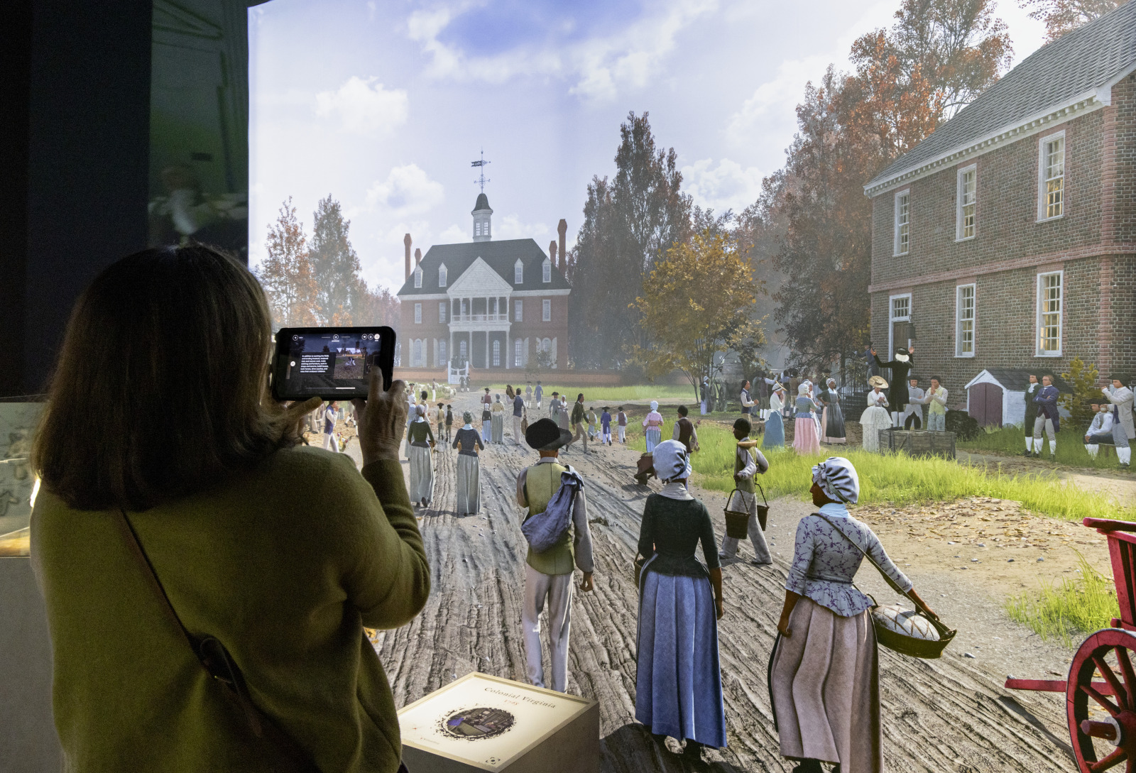 A visitor explores "American Revolution: The Augmented Exhibition" at the Historic New Orleans Collection.