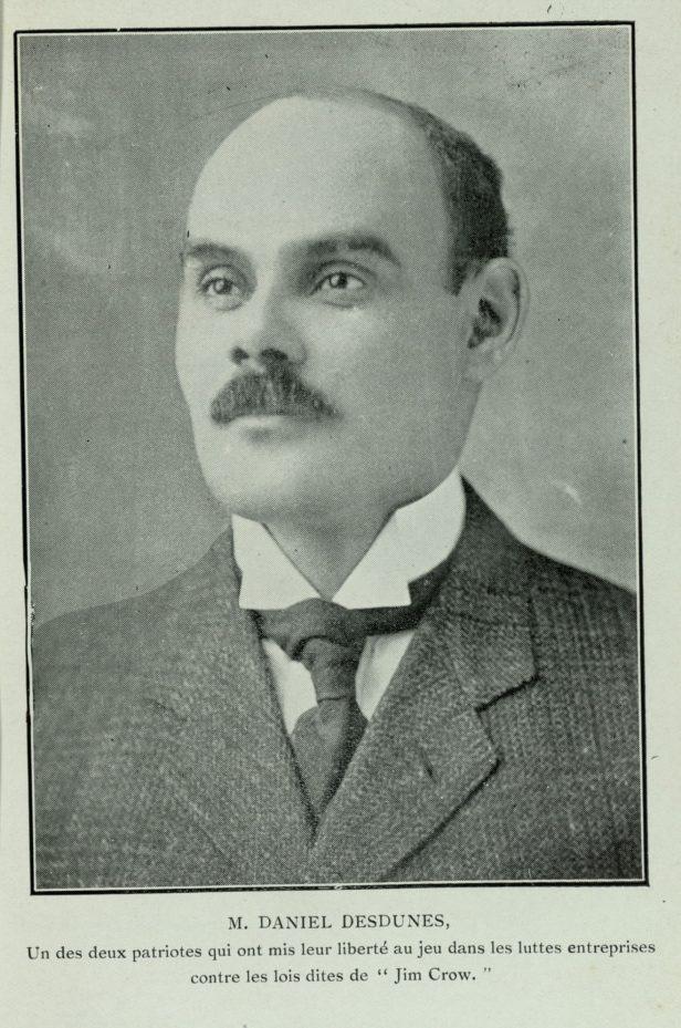 A black and white portrait of a man in a suit and bow tie. Text below reads: M. Daniel Desdunes, un des deux patriotes qui ont mis leur liberté au jeu dans les luttes entreprises contre les lois dites de Jim Crow..