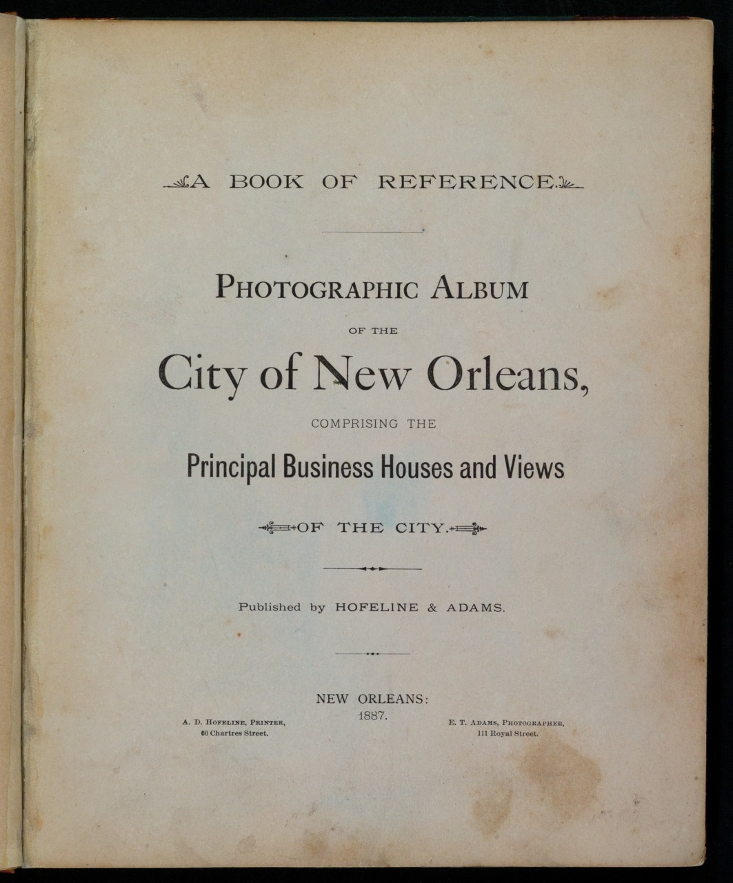 A vintage book cover titled A Book of Reference: Photographic Album of the City of New Orleans, Comprising the Principal Business Houses and Views of the City. Published by Hopeline & Adams in 1887.