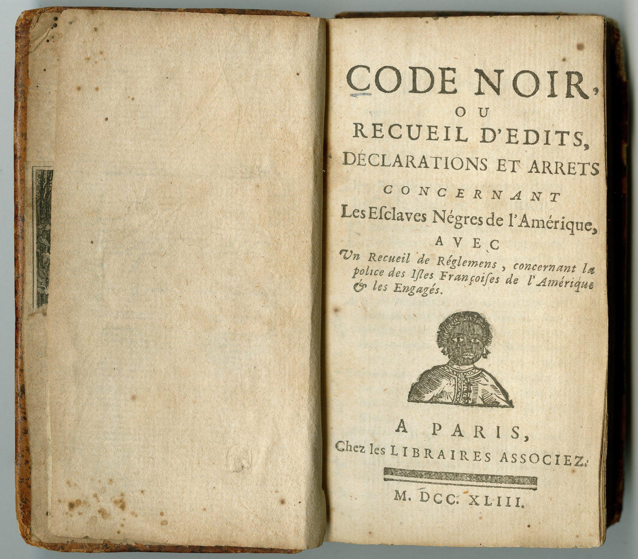 An open old book titled Code Noir, discussing laws regarding enslaved people in the Americas. The page displays a title, publication details in French, and a small illustration of a person at the bottom.