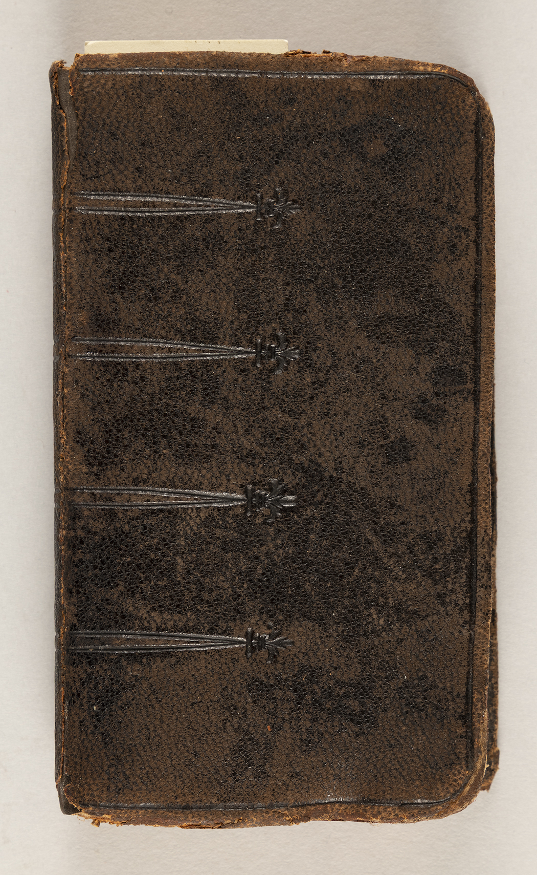 The front cover of a leather-bound prayer book.
