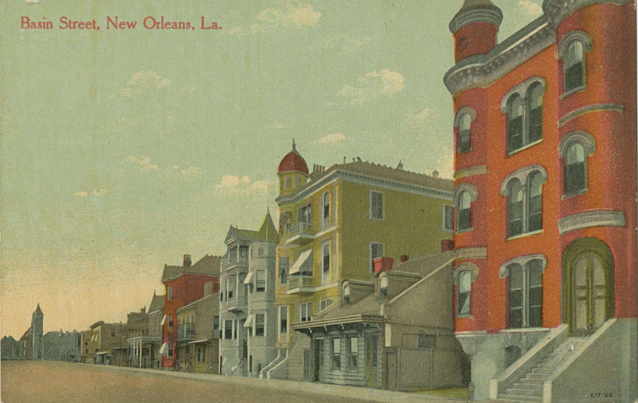 Vintage postcard of Basin Street, New Orleans, Louisiana, featuring historic buildings with intricate architectural details under a partly cloudy sky. The scene captures the charm and character of the early 20th century.