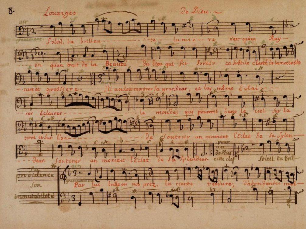 An image of a vintage sheet music page with handwritten musical notes and lyrics in French. The title at the top reads Louanges de Dieu. The sheet has a mix of brown and red ink, showing music notations and text.