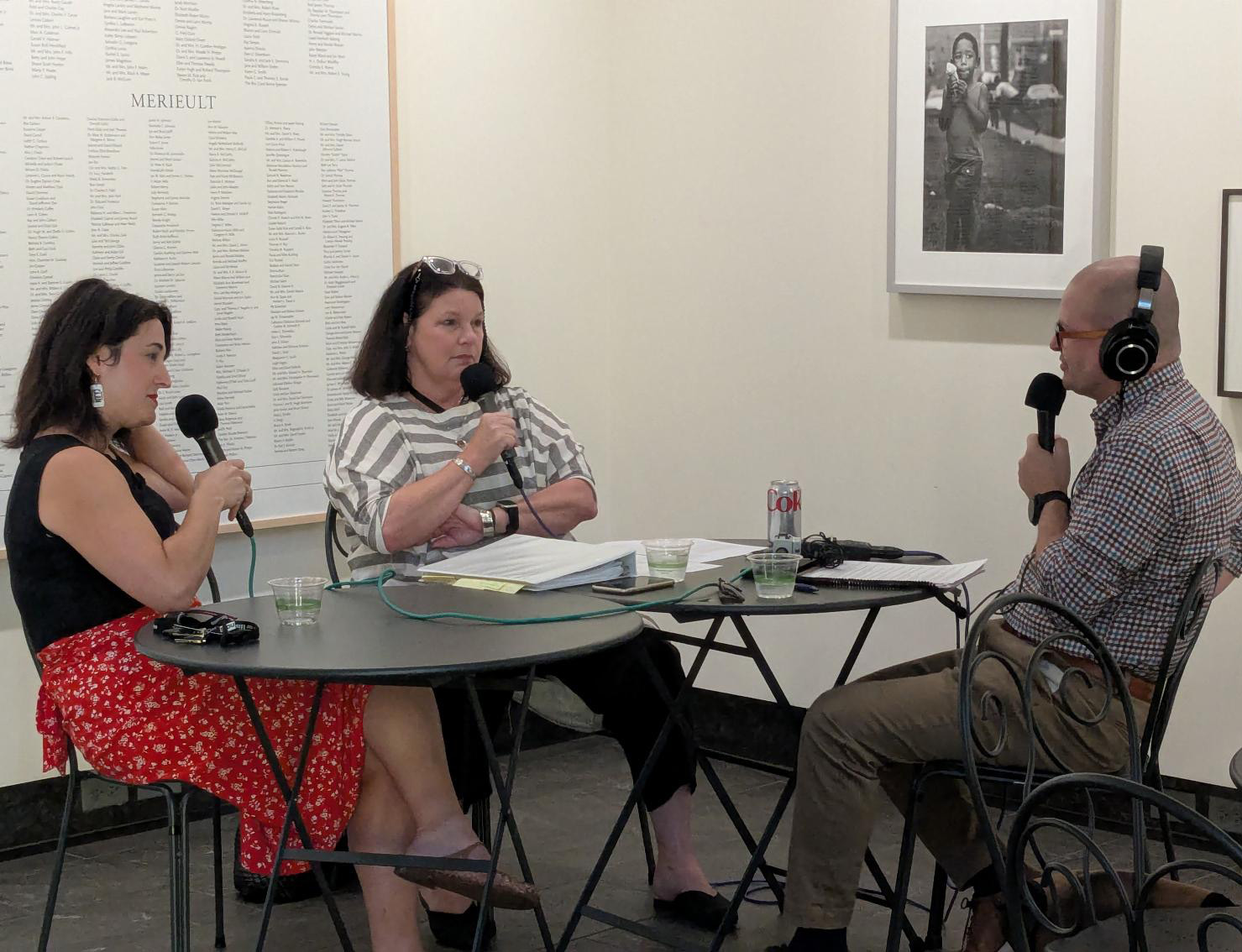 Two women and a man having an interview in a museum space.