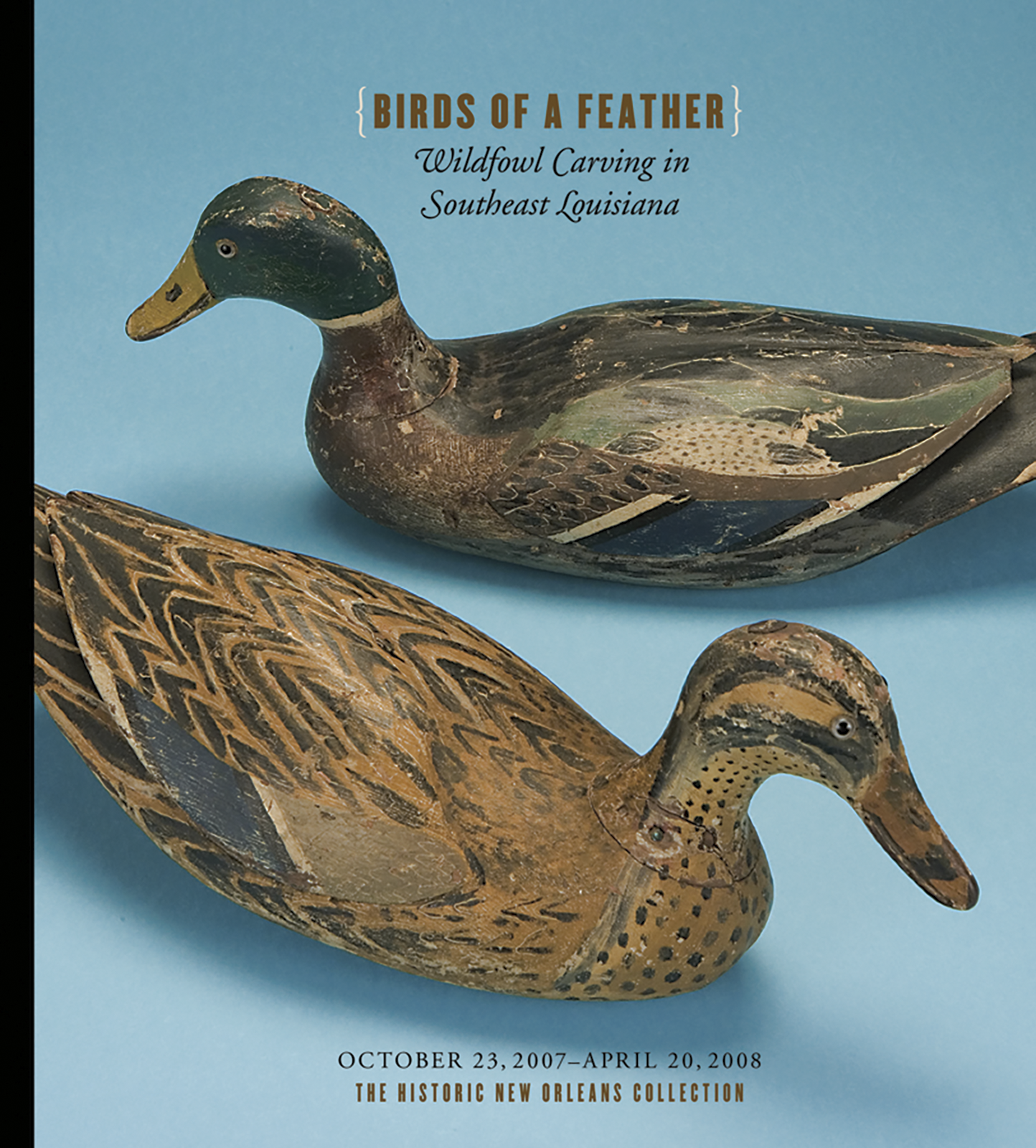 Two carved wooden ducks are displayed on a blue background beneath text reading Birds of a Feather: Wildfowl Carving in Southeast Louisiana, with exhibition dates and location at the bottom.