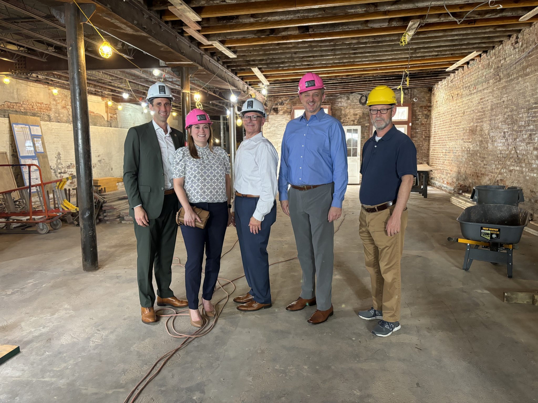 A posed photo of Daniel Hammer, Jessica Ortiz, Marty Cosgrove, Joel Poole, and Michael Cohn inside a construction site on the former site of K Paul's Restaurant in the French Quarter.