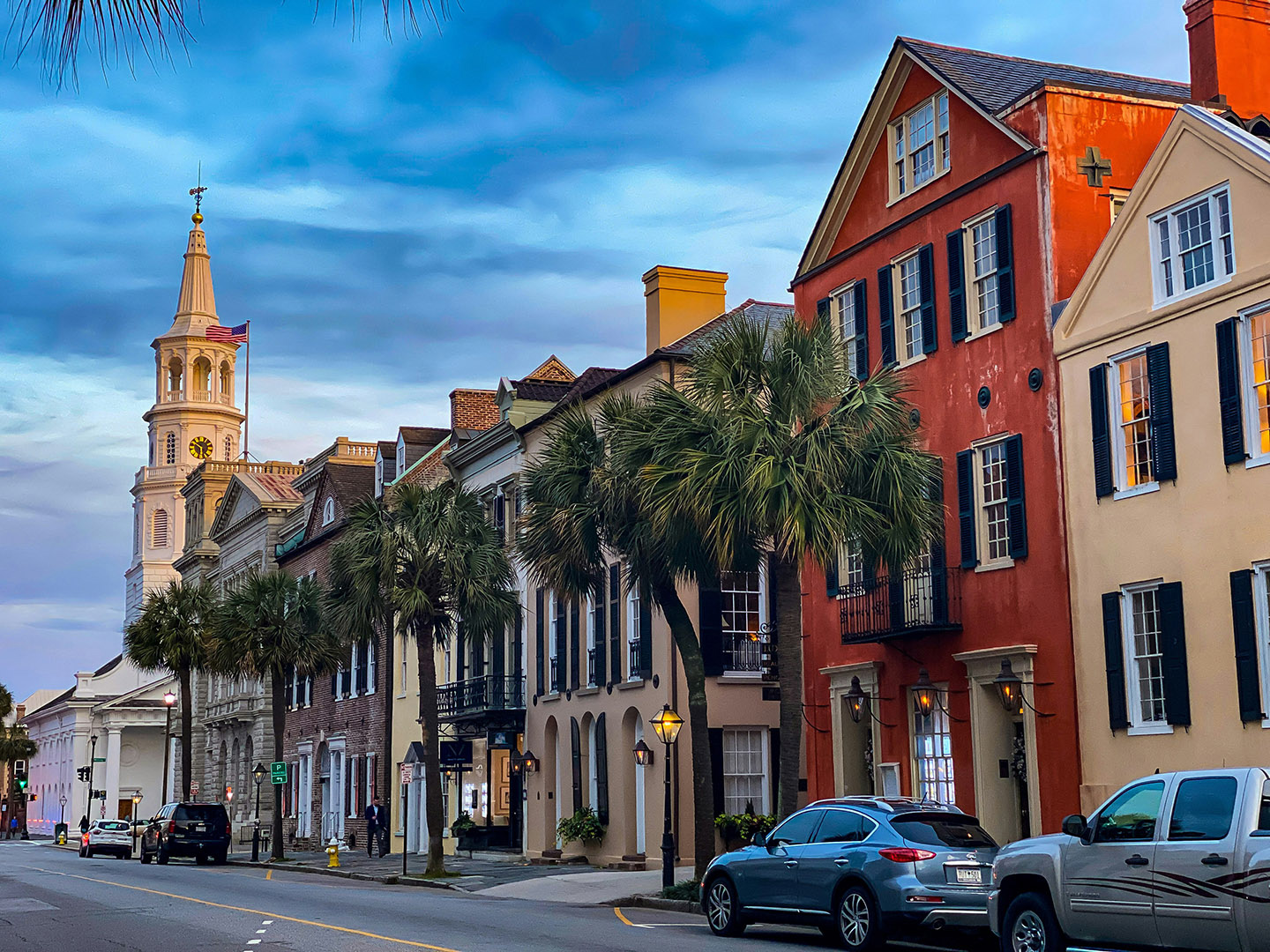 A photograph of Rainbow Row in Charleston, showing colonial-era buildings painted in bright colors.