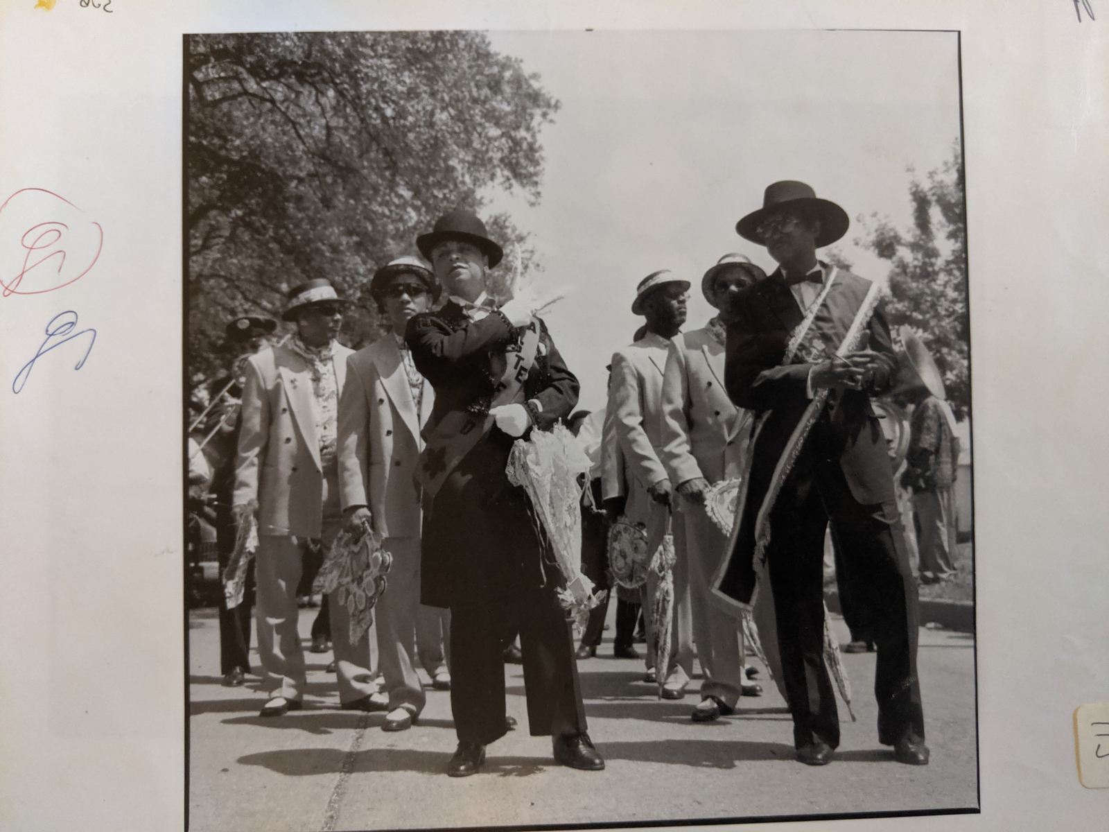 A vintage black and white photo shows a second line parade for Blu Lu Barker’s funeral.