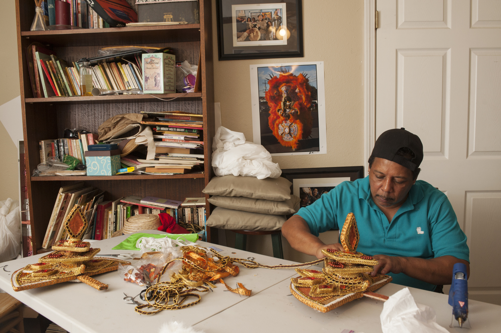 Tyrone “Pie” Stevenson does beadwork at a table in his home.