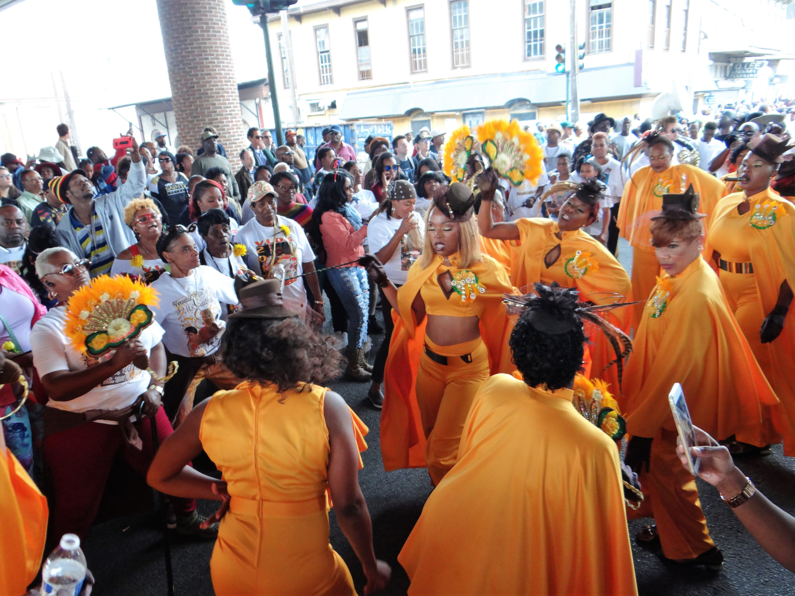 Versatile Ladies of Style members dance under the Claiborne overpass in the Tremé neighborhood, joined by members of the crowd.