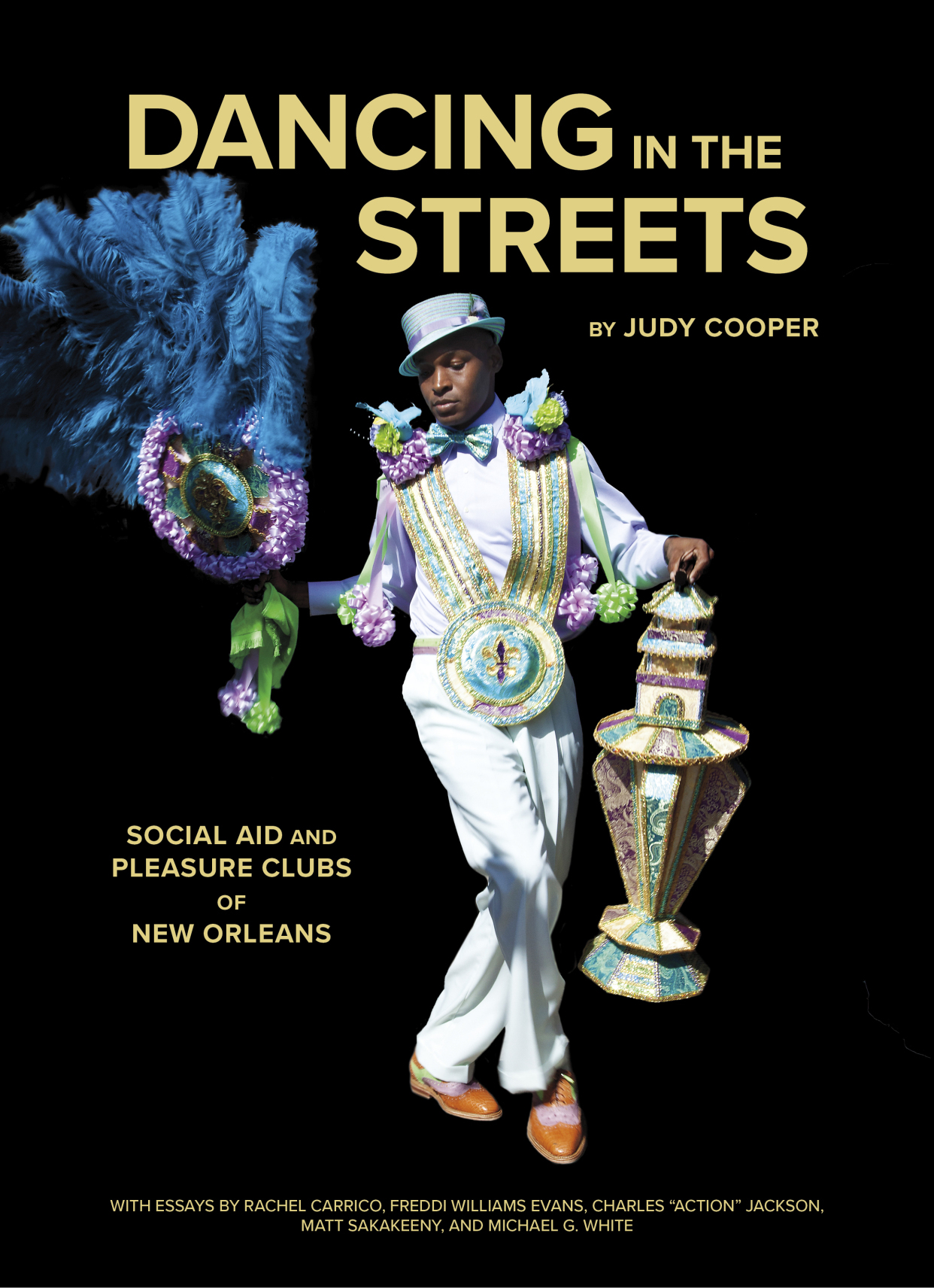 A person dressed in an elaborate, colorful costume poses with a decorated umbrella and an ornate adornment, set against a black background. The text reads Dancing in the Streets by Judy Cooper, about social aid and pleasure clubs of New Orleans.