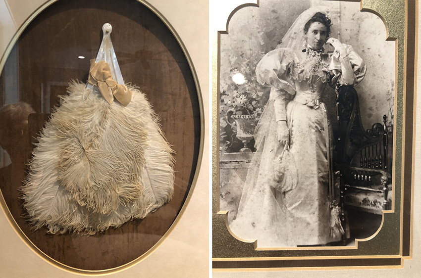 A vintage display features a feathered fan with a bow on the left and an old-fashioned black-and-white photograph of a woman in a wedding dress on the right.