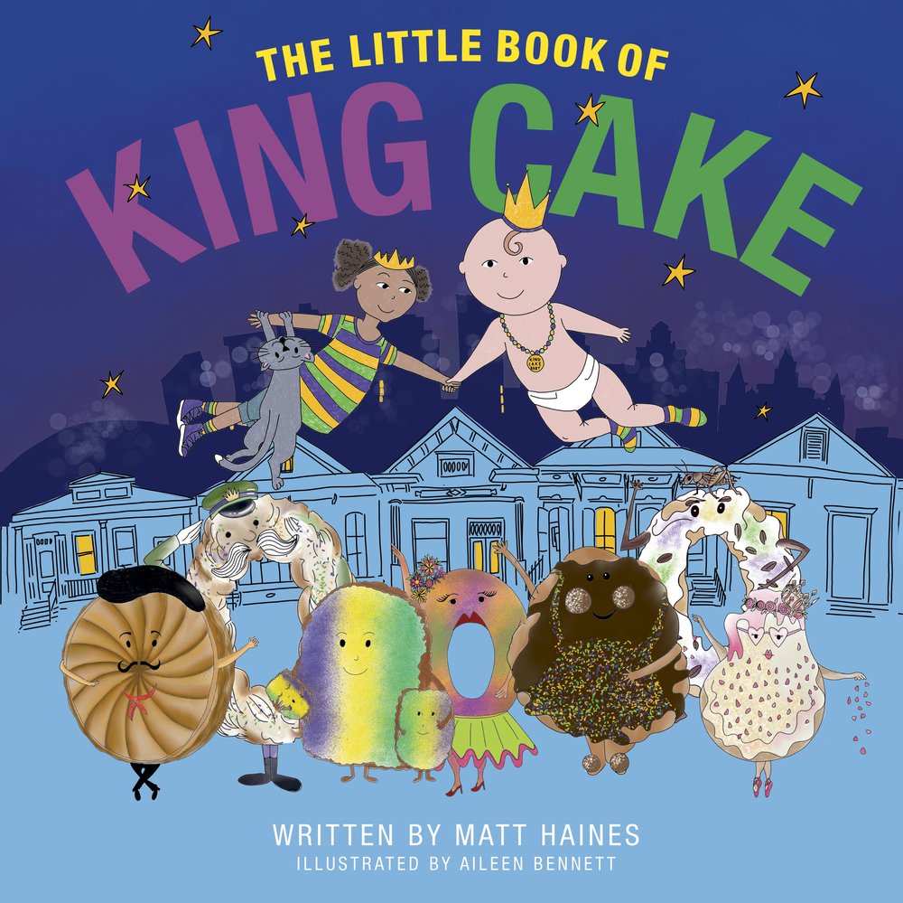 Illustrated cover of The Little Book of King Cake by Matt Haines, featuring various colorful cake characters and two babies in crowns against a backdrop of a building and night sky.