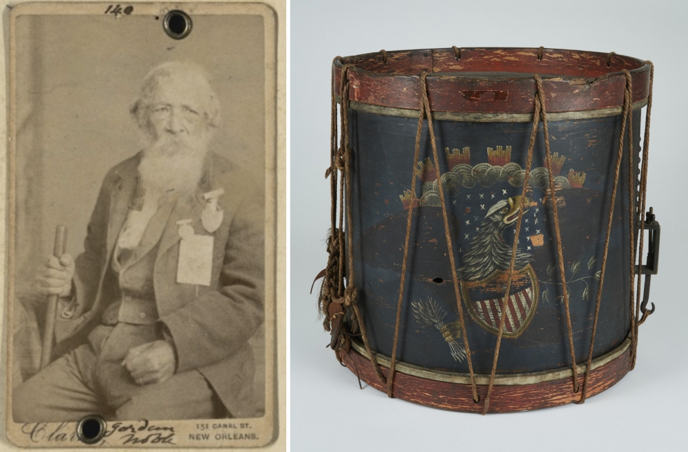 A vintage sepia photograph of an elderly man holding a cane is on the left. On the right, theres an old, weathered drum with a painted emblem featuring an eagle and shield. The drum is decorated with ropes and worn edges.