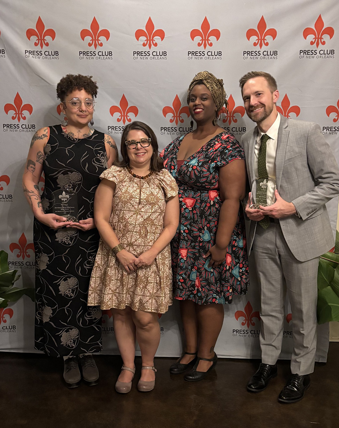 HNOC staff members Terri Simon, Erin M. Greenwald, PhD, Kelley Hines, and Nick Weldon pose for a photo as they accept awards at the 2026 New Orleans Press Club Awards.