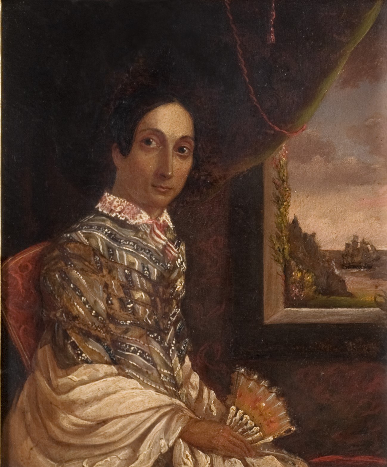 A woman in traditional attire sits by a window holding a fan. The background shows a seascape with a ship on the horizon. She wears a shawl with intricate patterns and gazes towards the viewer.