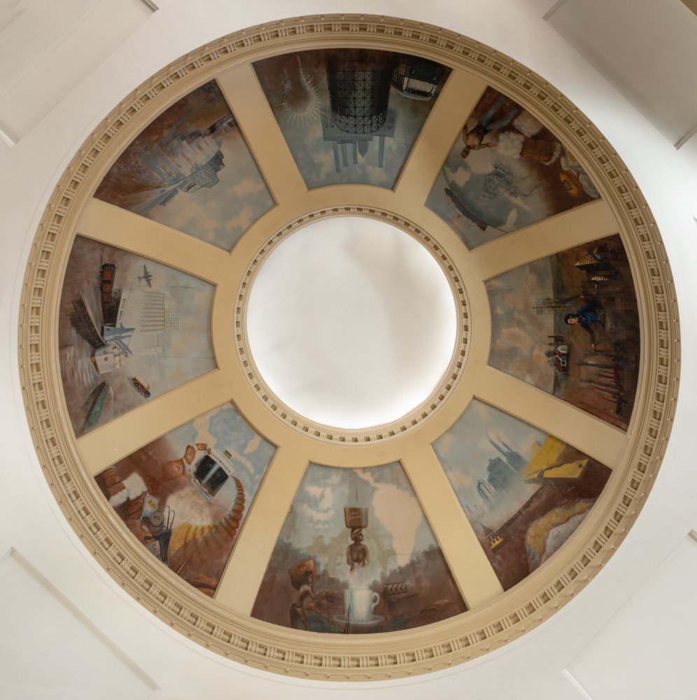 Ceiling dome featuring eight mural segments depicting scenes of industrial and technological advancements, including machinery, architecture, and transportation. The dome is richly detailed and centered around a circular opening.