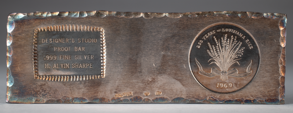 A silver bar featuring two engravings. On the left, a rectangular plaque reads: DESIGNERS STUDIO, PROOF BAR, .999 FINE SILVER, H. ALVIN SHARPE. On the right, a circular design commemorates 250 Years of Louisiana Rice, 1969 with rice stalks.