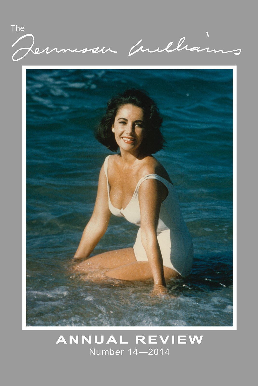 A woman in a white swimsuit kneels in shallow ocean water, smiling. The image is framed by a gray border with text reading Tennessee Williams: Annual Review Number 14—2014 at the top and bottom.