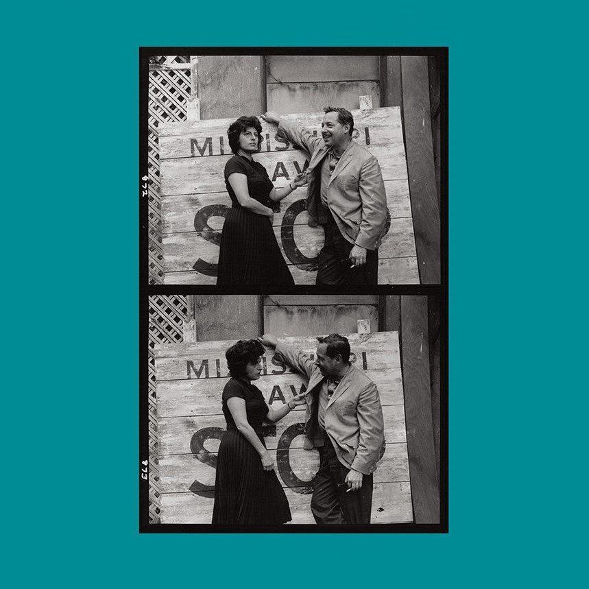 Vintage black and white photo with two images of a man in a suit playfully interacting with a woman in a dress against a rustic backdrop, featuring a wooden sign with partially visible text.