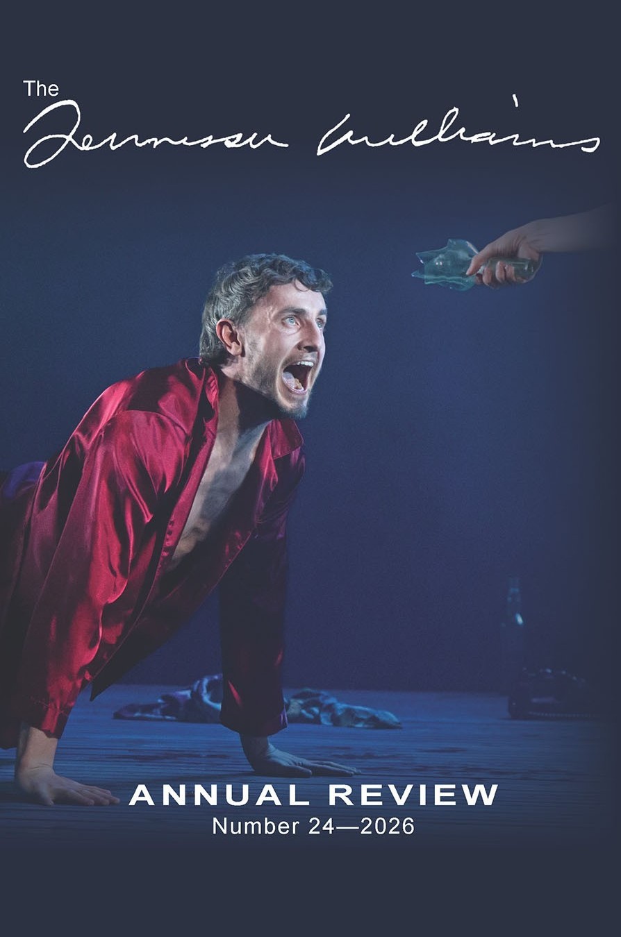 Journal cover with photograph of scene from a stage performance: on the left side, a young man wearing red pajamas crouches on stage and yells angrily at an unseen person whose hand extends toward him from the right side of the image, holding the neck of a broken glass bottle.