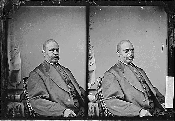 A black and white vintage photo showing a man in a suit sitting on an ornate chair. The image is duplicated side by side, resembling a stereoscopic effect. The man appears calm and composed, with a blurred background.