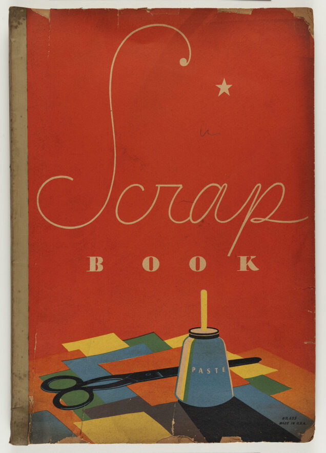 Vintage scrapbook cover with Scrap Book written on a red background. Below, theres a small star, a jar labeled Paste, and scissors on colorful paper cutouts. The edges appear worn, giving it an old-fashioned feel.