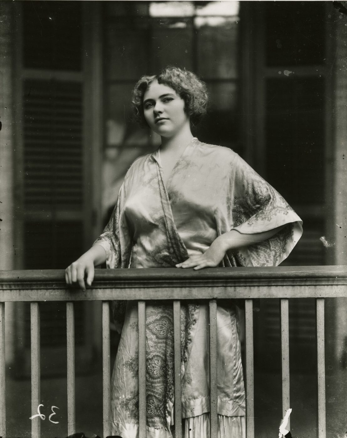 Storyville woman standing on balcony