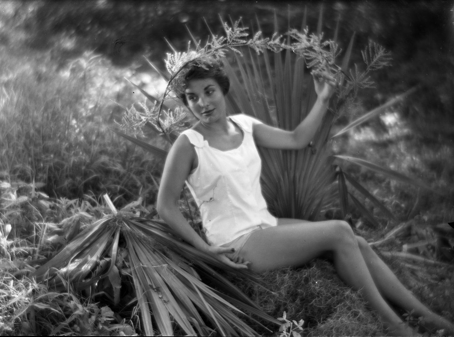 Portrait of a woman posing in front of a palmetto, by Eugene A. Delcroix.