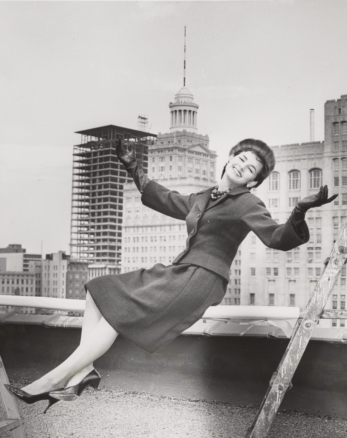 Black and white photo of Betty Killeen modeling an outfit atop the States-Item Building, 1961, by James Perrier Guillot.