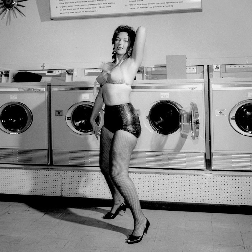 Woman posing in lengerie at dry cleaning business for a Norge Dry Cleaning advertisement