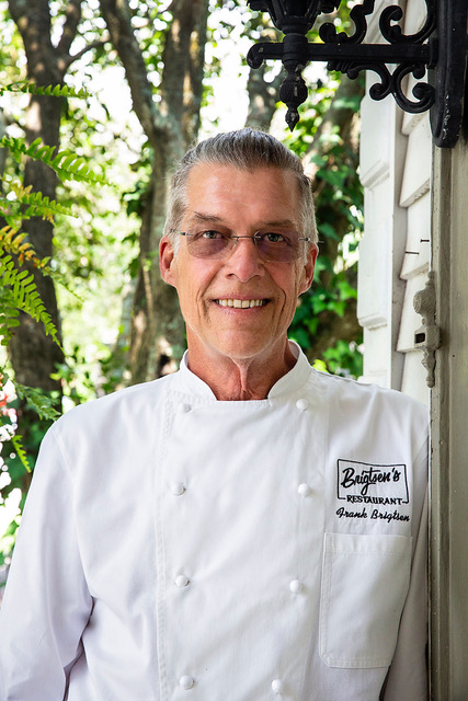 Headshot of Chef Frank Brigtsen. He is wearing a chef's jacket.