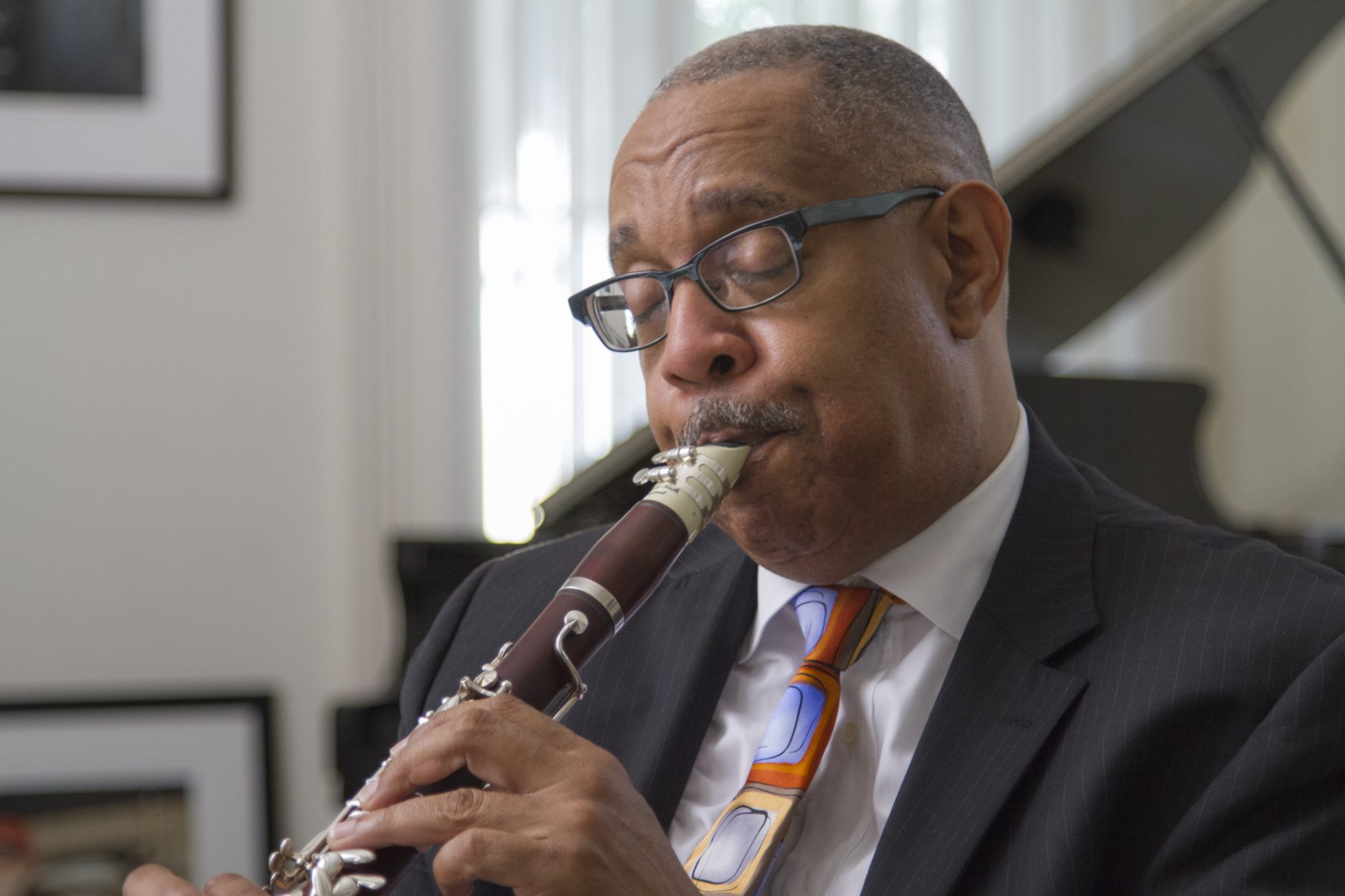 Headshot for Dr. Michael White showing him playing clarinet