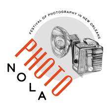 Logo for PhotoNOLA features a vintage camera illustration with a flash. The word PHOTO is written vertically in bold red letters intersecting NOLA horizontally. The text Festival of Photography in New Orleans is arched above.