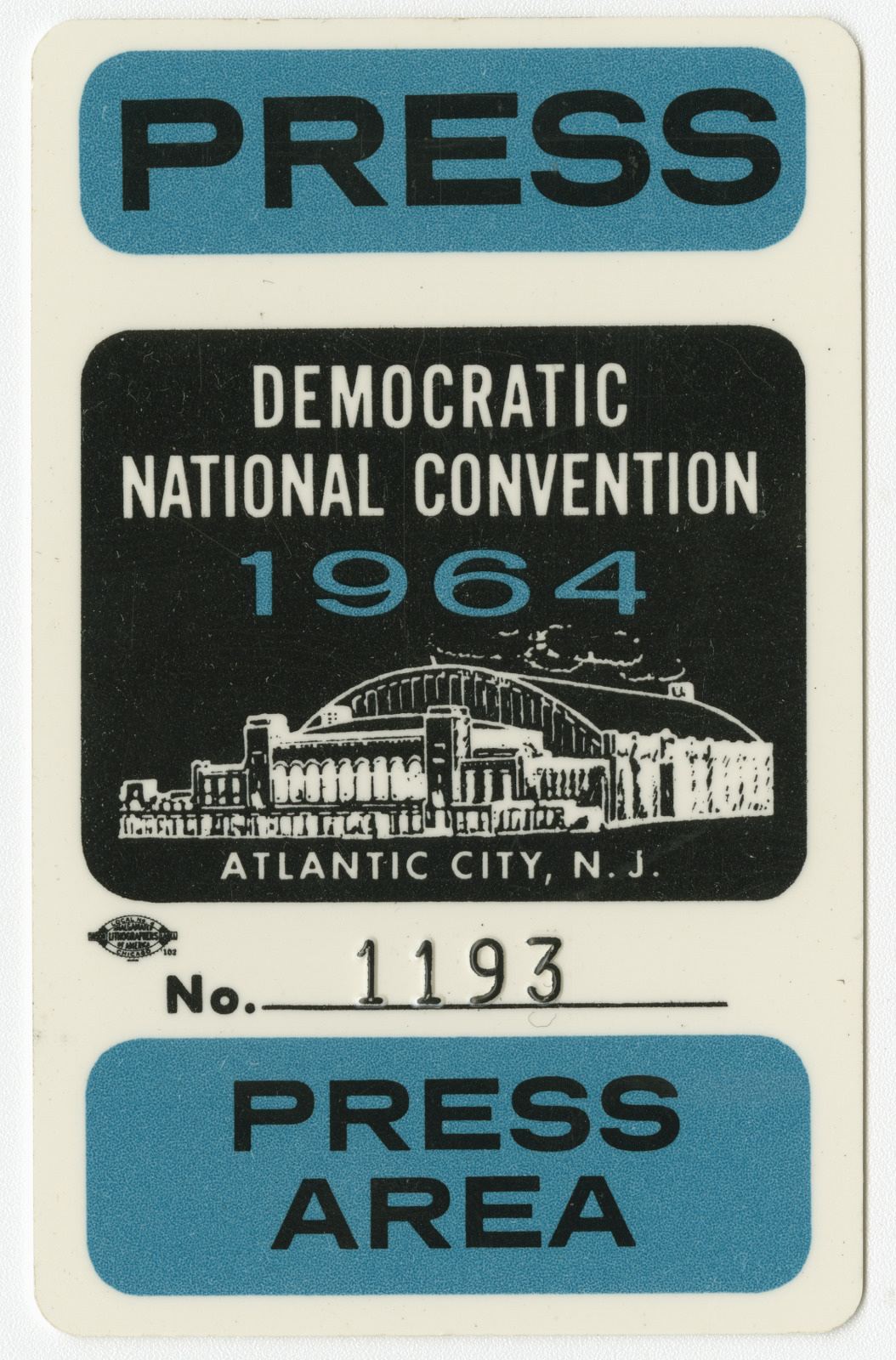 A press pass for the 1964 Democratic National Convention in Atlantic City, N.J., featuring a depiction of a convention center and number 1193. The pass has PRESS and PRESS AREA highlighted in blue.