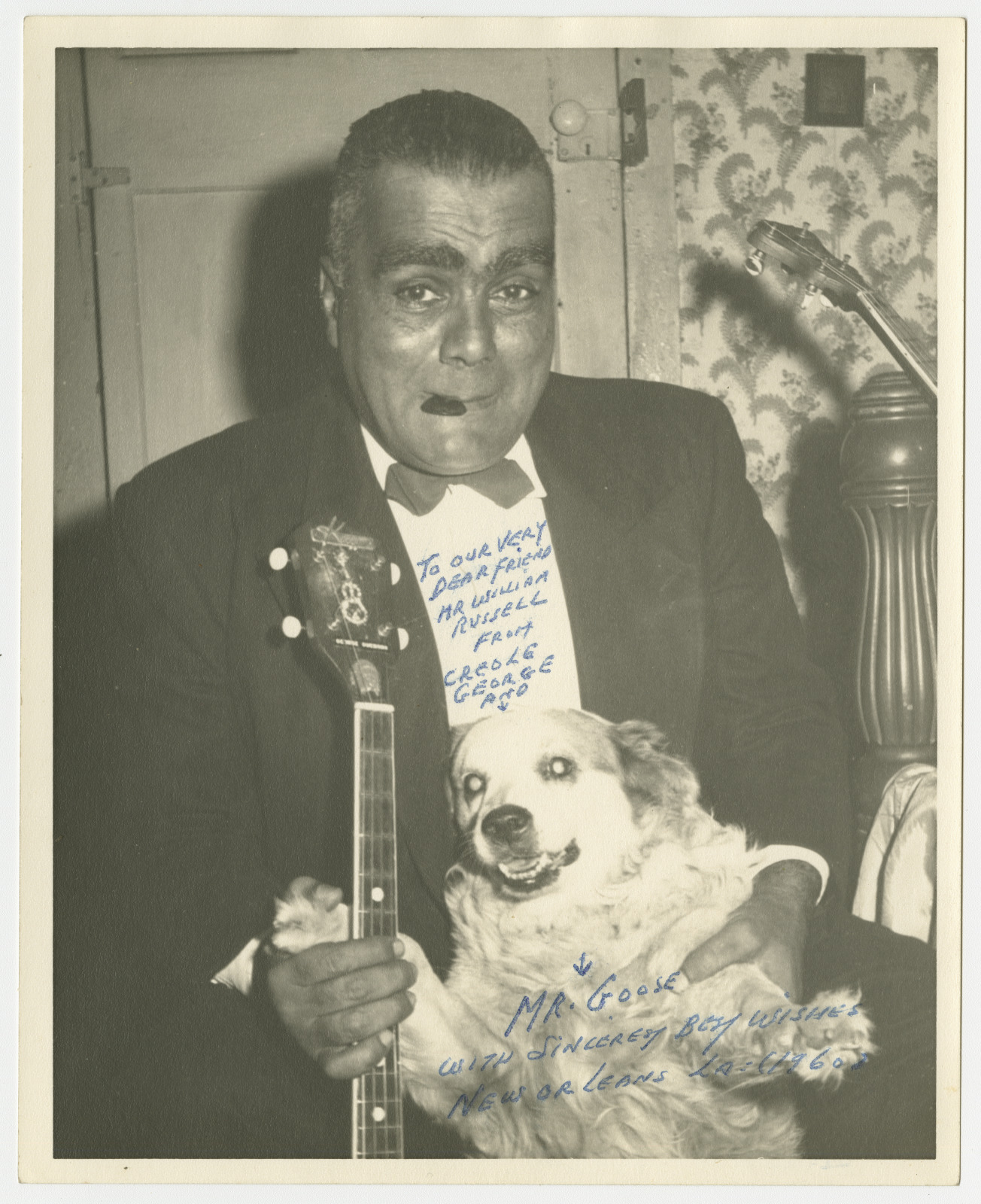 Musician “Creole” George Guesnon poses with his pup, Mr. Goose in a signed photo.