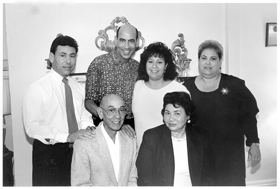 A black and white family portrait shows Larry, Vernel, Gina, and Joanne Bagneris with their parents, Lawrence and Gloria.
