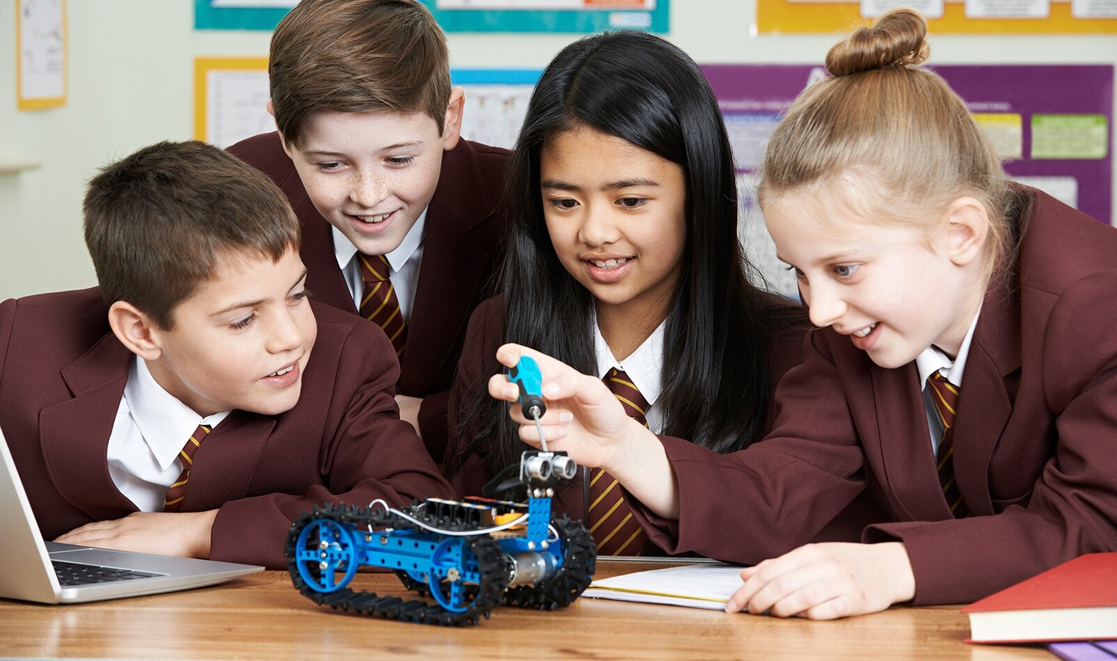 School students working with laptop for robotics STEM