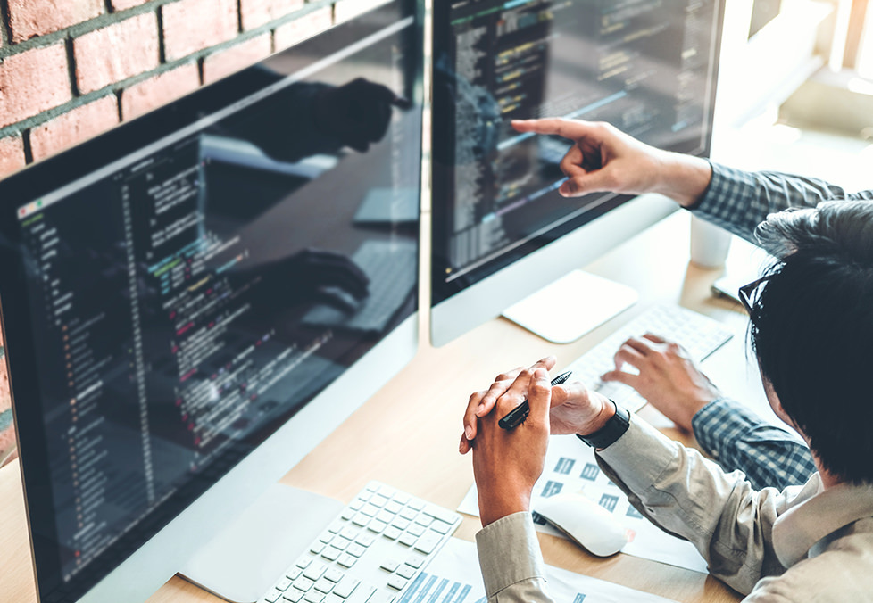 Two analysts reviewing code