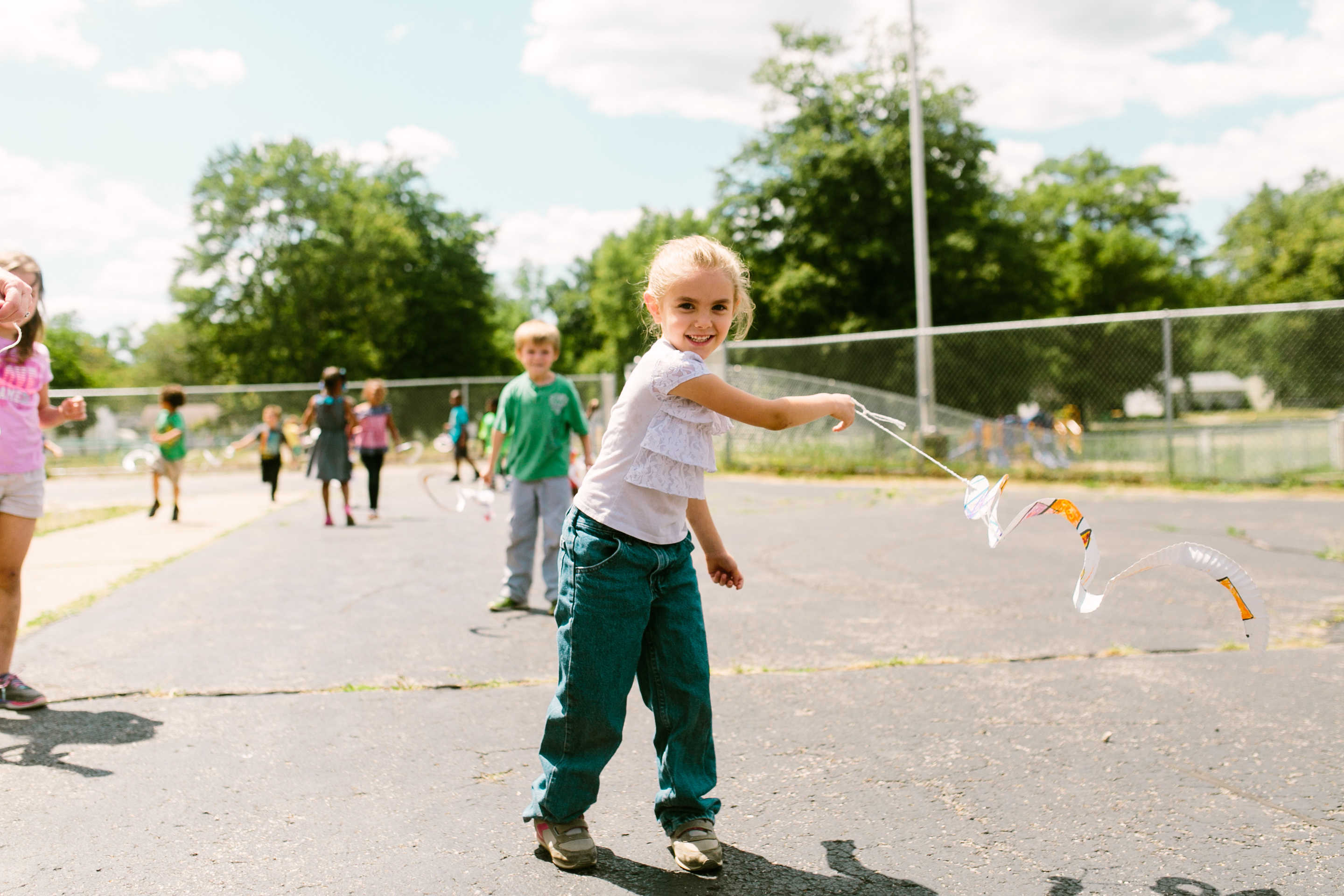 girl playing with mobile at recess