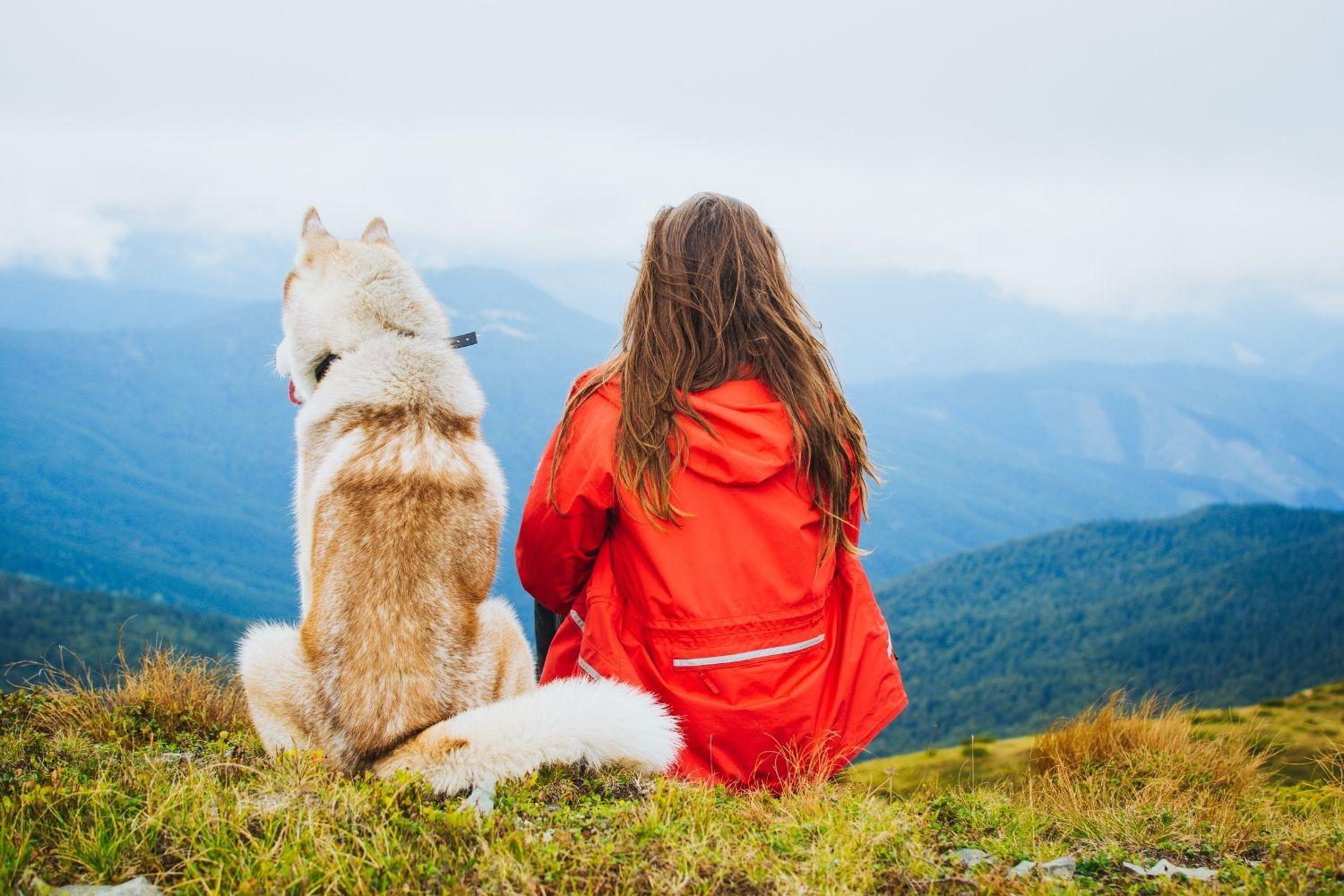 Sitting with Husky on hike