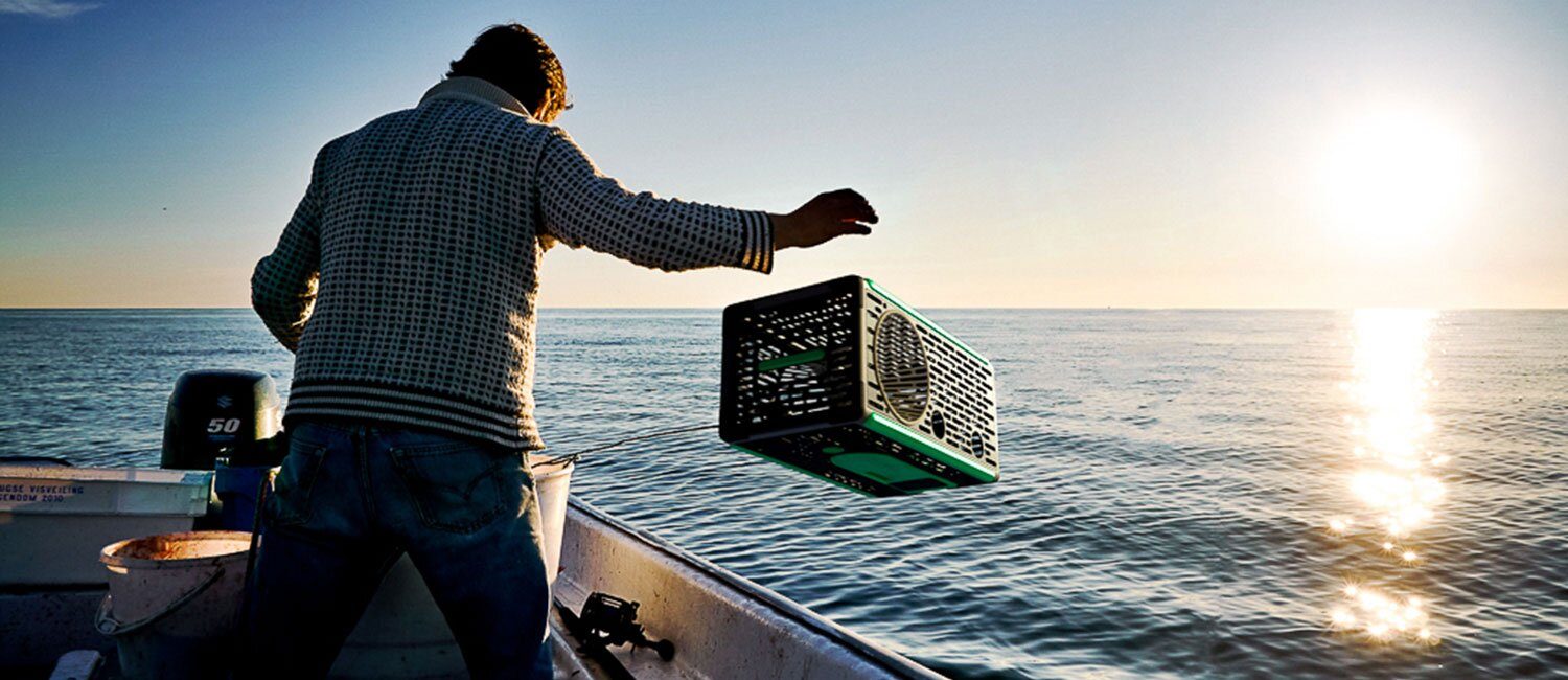 En teinefisker i varmt motlys kaster en teine (Being bouyant) i havet.