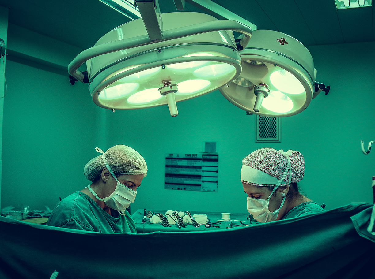 Two person doing surgery inside room 1250655
