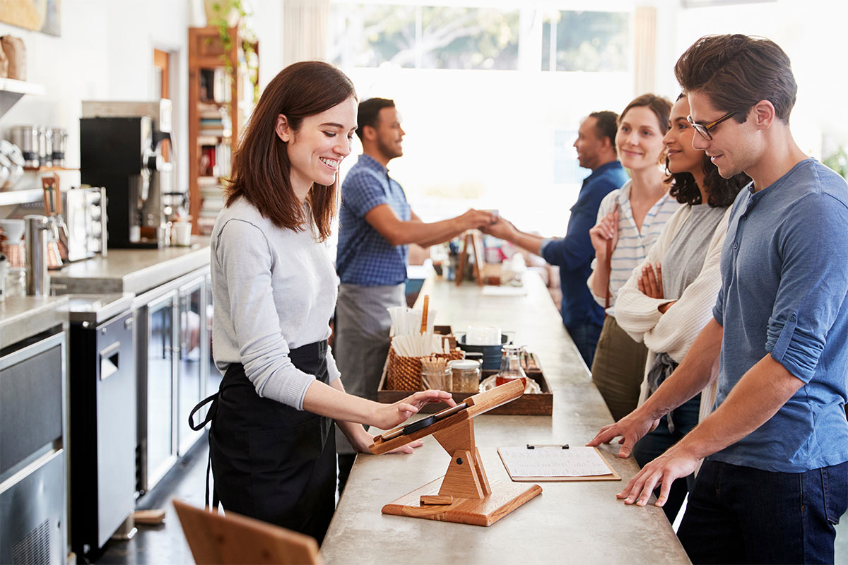 Restaurant employee taking an order from a customer