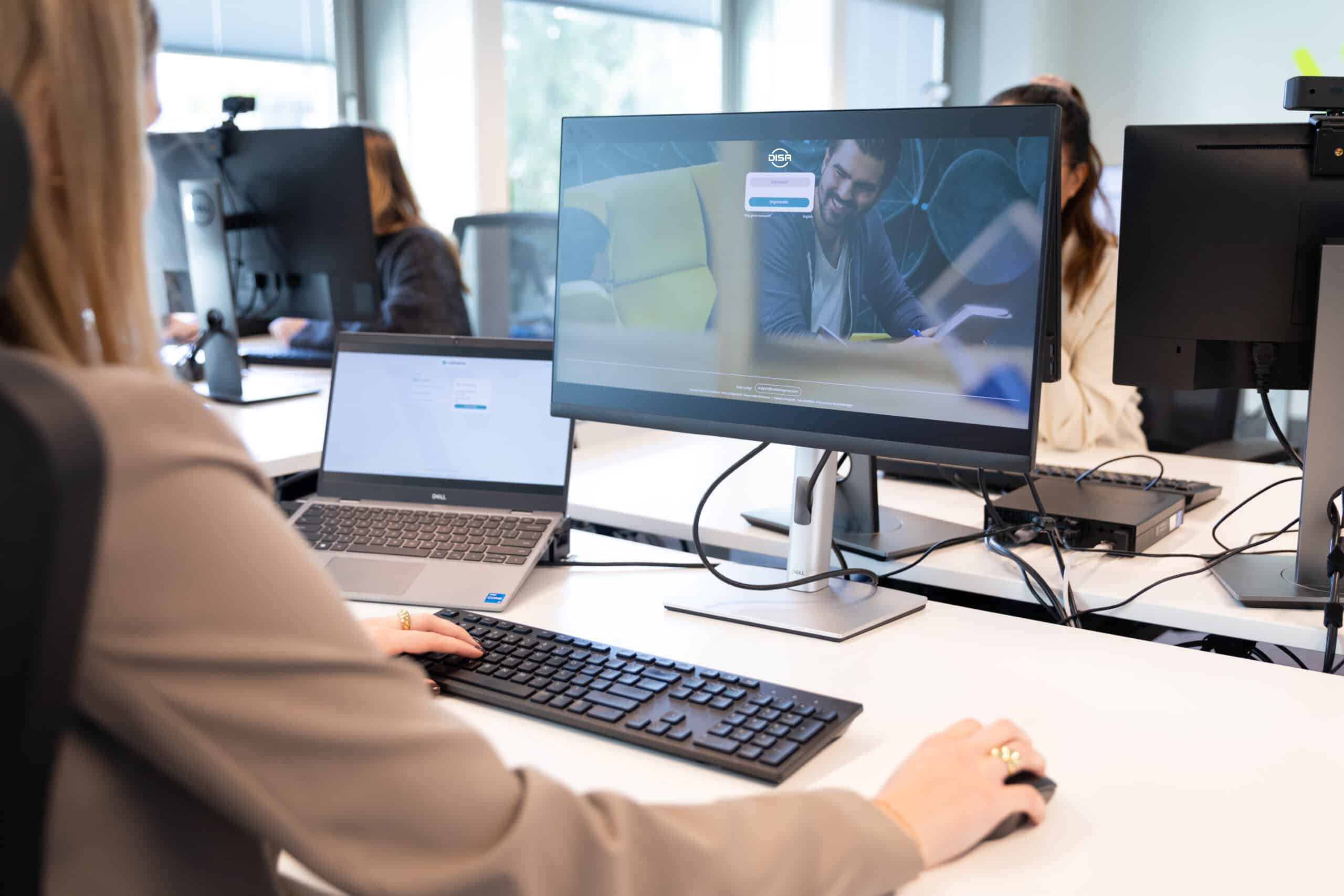 Worker at a desk logging into DISA platform