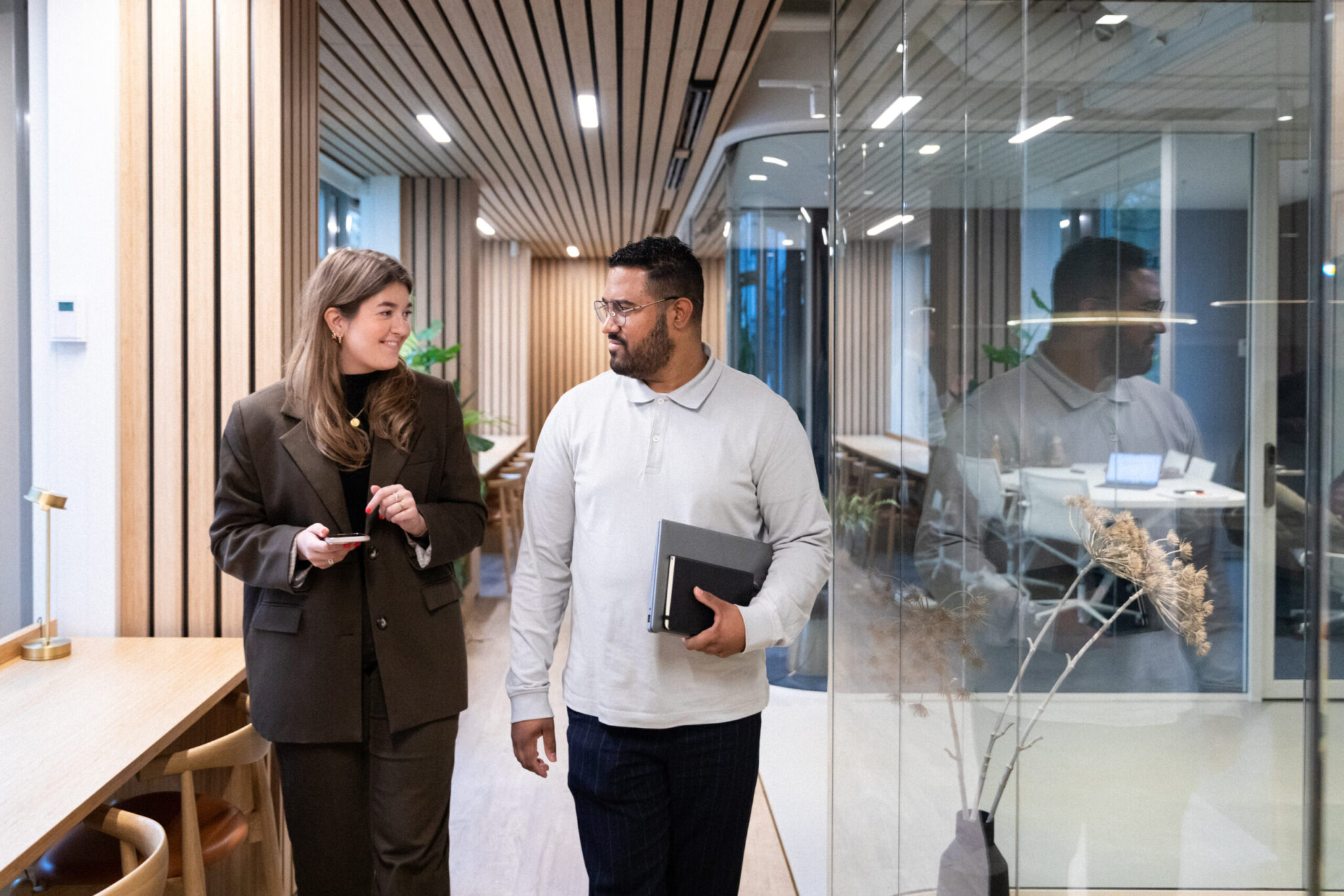 two coworkers conversing in office
