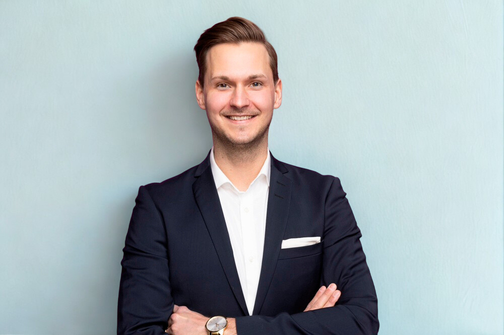 Man in suit with light blue background