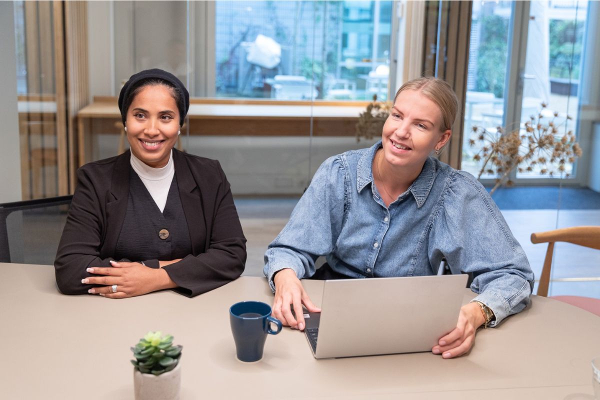 Two women sitting at an office table